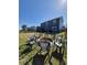 Backyard featuring a fire pit surrounded by chairs and green grass at 897 Wild Leaf Loop, Conway, SC 29526
