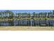 Scenic backyard view of a pond with a black fence and bench for relaxation and privacy at 897 Wild Leaf Loop, Conway, SC 29526