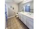 Bathroom with double vanity, tile floor, and blue shower curtain at 897 Wild Leaf Loop, Conway, SC 29526