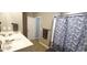Well-lit bathroom with a double vanity, leafy shower curtain, and neutral-colored walls at 897 Wild Leaf Loop, Conway, SC 29526