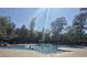 Community pool with children playing, surrounded by lounge chairs and lush green trees at 897 Wild Leaf Loop, Conway, SC 29526