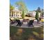Outdoor firepit with Adirondack chairs offers a cozy gathering spot, surrounded by manicured landscaping and seating at 897 Wild Leaf Loop, Conway, SC 29526