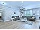 Spacious living room featuring modern wood plank wall, ceiling fan and large sectional couch at 897 Wild Leaf Loop, Conway, SC 29526