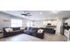 Spacious living room featuring a large sectional sofa and an open layout into the kitchen area at 897 Wild Leaf Loop, Conway, SC 29526