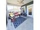 Relaxing screened porch with comfortable seating, ceiling fan and outdoor rug at 897 Wild Leaf Loop, Conway, SC 29526