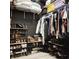 Well organized walk-in closet providing plentiful hanging and shelf storage for shoes and clothes at 897 Wild Leaf Loop, Conway, SC 29526
