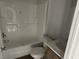 Bright bathroom with tub and shower combo, toilet, and modern single sink vanity at 928 Baron Ln., North Myrtle Beach, SC 29582