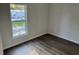 Cozy bedroom showcasing wood floors, a bright window, and electrical outlets at 928 Baron Ln., North Myrtle Beach, SC 29582