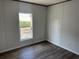 Cozy bedroom showcasing wood floors, a bright window, and electrical outlets at 928 Baron Ln., North Myrtle Beach, SC 29582