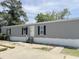 Gray single Gathering home with black shutters and short entryway steps at 928 Baron Ln., North Myrtle Beach, SC 29582