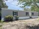 A charming gray single Gathering home with black shutters on a sunny day at 928 Baron Ln., North Myrtle Beach, SC 29582