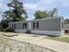 Gray single Gathering home with black shutters and a concrete driveway at 928 Baron Ln., North Myrtle Beach, SC 29582