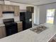 Kitchen featuring wood-look cabinets and a kitchen island with a sink at 928 Baron Ln., North Myrtle Beach, SC 29582