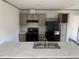 Kitchen featuring wood-look cabinets and a kitchen island with a sink at 928 Baron Ln., North Myrtle Beach, SC 29582