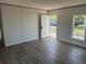 Bright living room with light grey walls and wood-look vinyl floors at 928 Baron Ln., North Myrtle Beach, SC 29582