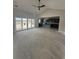 Open concept living space with sliding glass door and view into the dark-cabinetry kitchen at Tbd 61 Persimmon Rd., Aynor, SC 29511