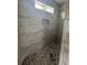 Detailed close-up of tiled shower with stone floor and built-in shelf at Tbd 61 Persimmon Rd., Aynor, SC 29511