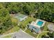 A lovely aerial view showing a pool, hot tub, and tennis courts with lush, green trees in the background at 10301 N Kings Hwy. # 8-1, Myrtle Beach, SC 29572