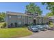 Exterior view of condo showcasing gray siding, white trim, green lawn, and parking at 10301 N Kings Hwy. # 8-1, Myrtle Beach, SC 29572