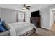Comfortable bedroom with a decorative fireplace, ceiling fan, and a window at 10301 N Kings Hwy. # 8-1, Myrtle Beach, SC 29572