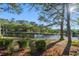 Beautiful backyard view of the lake, with mature trees providing shade on a sunny day at 111 Cedar Ridge Ln., Conway, SC 29526