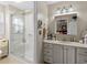 Bathroom with glass shower, toilet, sink, drawers, and well-lit mirror at 111 Cedar Ridge Ln., Conway, SC 29526