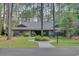 Charming brick home with mature landscaping and a circular flower bed at 111 Cedar Ridge Ln., Conway, SC 29526