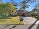 A well-maintained single-story home with a driveway, manicured lawn and mature trees at 111 Cedar Ridge Ln., Conway, SC 29526