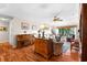 Open-concept living room with hardwood floors, piano, comfortable seating, and a scenic view at 111 Cedar Ridge Ln., Conway, SC 29526