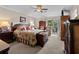 Main bedroom with ceiling fan, dresser, and sliding glass door to the backyard and pond at 111 Cedar Ridge Ln., Conway, SC 29526
