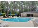 Outdoor swimming pool with seating, sun umbrellas and a nearby pool house at 111 Cedar Ridge Ln., Conway, SC 29526