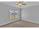 Carpeted bedroom with neutral walls and lots of light from two big windows at 1222 Nw Calabash Station Blvd., Calabash, NC 28467
