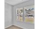Sunlit empty room featuring neutral walls, carpet flooring, and large windows overlooking the neighborhood at 1222 Nw Calabash Station Blvd., Calabash, NC 28467