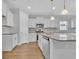 A view of the modern kitchen with white cabinets, stainless appliances, and granite countertops at 1222 Nw Calabash Station Blvd., Calabash, NC 28467