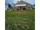 Backyard features lawn, patio with a retractable awning, outdoor seating and grill at 115 Foxford Dr., Conway, SC 29526