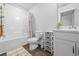 Well-lit bathroom with tub, decorative rug, and stylish vanity, creating a serene space at 115 Foxford Dr., Conway, SC 29526