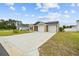 Charming home featuring a double garage, concrete driveway, and well-manicured lawn at 115 Foxford Dr., Conway, SC 29526