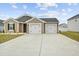 Charming home featuring a two-car garage, well-manicured lawn, and inviting facade with a blue sky backdrop at 115 Foxford Dr., Conway, SC 29526