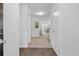 Inviting hallway featuring hardwood floors and view into living room and outdoor patio at 115 Foxford Dr., Conway, SC 29526