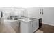 Open concept kitchen with island sink and stainless dishwasher seamlessly connects to the living space at 115 Foxford Dr., Conway, SC 29526