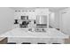 Modern kitchen with white cabinets, stainless steel appliances, marble island with bar seating, and hardwood floors at 115 Foxford Dr., Conway, SC 29526