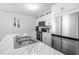 A kitchen showcases a stylish island sink paired with stainless steel appliances and white cabinets at 115 Foxford Dr., Conway, SC 29526