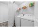 Convenient laundry room with washer, dryer, and shelving for storage, promoting organized living at 115 Foxford Dr., Conway, SC 29526