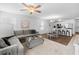 Open-concept living area with a comfortable sofa, dining table, and a stylish kitchen area with bar seating at 115 Foxford Dr., Conway, SC 29526
