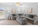 Inviting living room featuring a large sectional sofa, ceiling fan, and a view of the backyard at 115 Foxford Dr., Conway, SC 29526