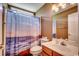 Full bathroom with a shower/tub combo, vanity, and a beach themed shower curtain at 1154 Lampwick Ln., Murrells Inlet, SC 29576