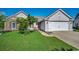 Charming single-Gathering home featuring a two-car garage, manicured lawn and inviting red door at 1154 Lampwick Ln., Murrells Inlet, SC 29576