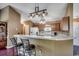 Kitchen with a breakfast bar, hardwood floors, wooden cabinets, and modern appliances at 1154 Lampwick Ln., Murrells Inlet, SC 29576