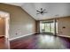 Bright living room featuring hardwood floors, high ceilings, and a large window at 1154 Lampwick Ln., Murrells Inlet, SC 29576