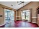 Living room with hardwood floors, sliding glass doors to sunroom, and a large window at 1154 Lampwick Ln., Murrells Inlet, SC 29576